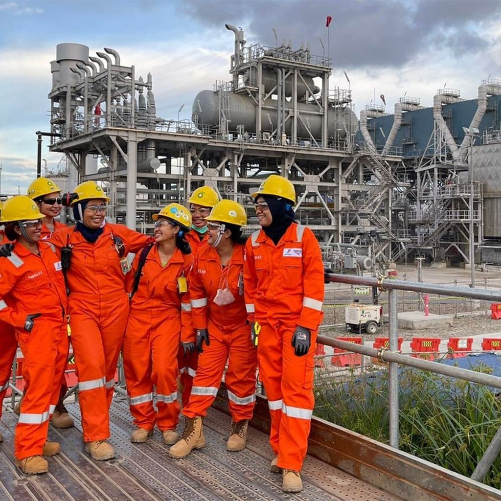Industrial workers in safety gear at a manufacturing facility
